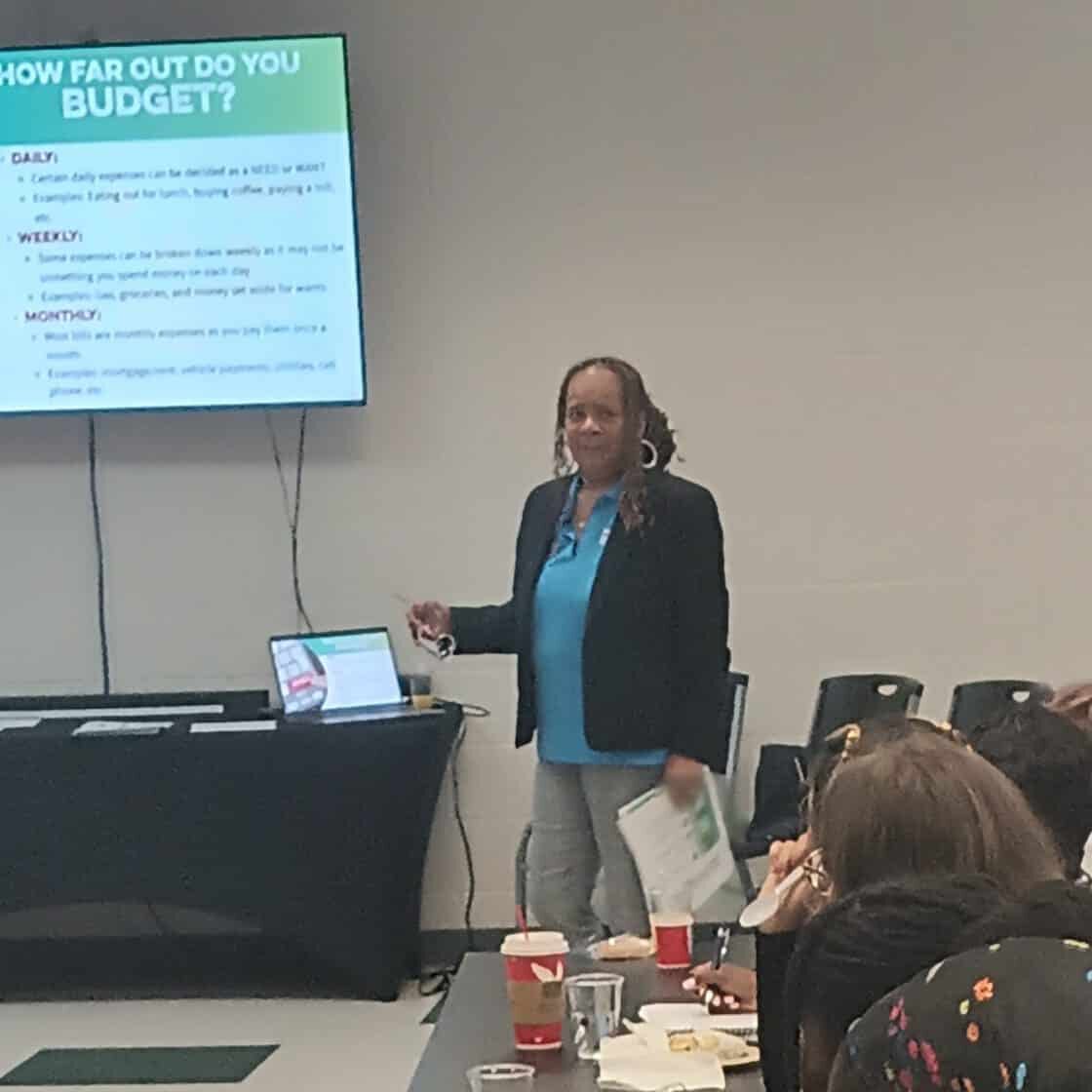 Woman giving a presentation in front of a large screen