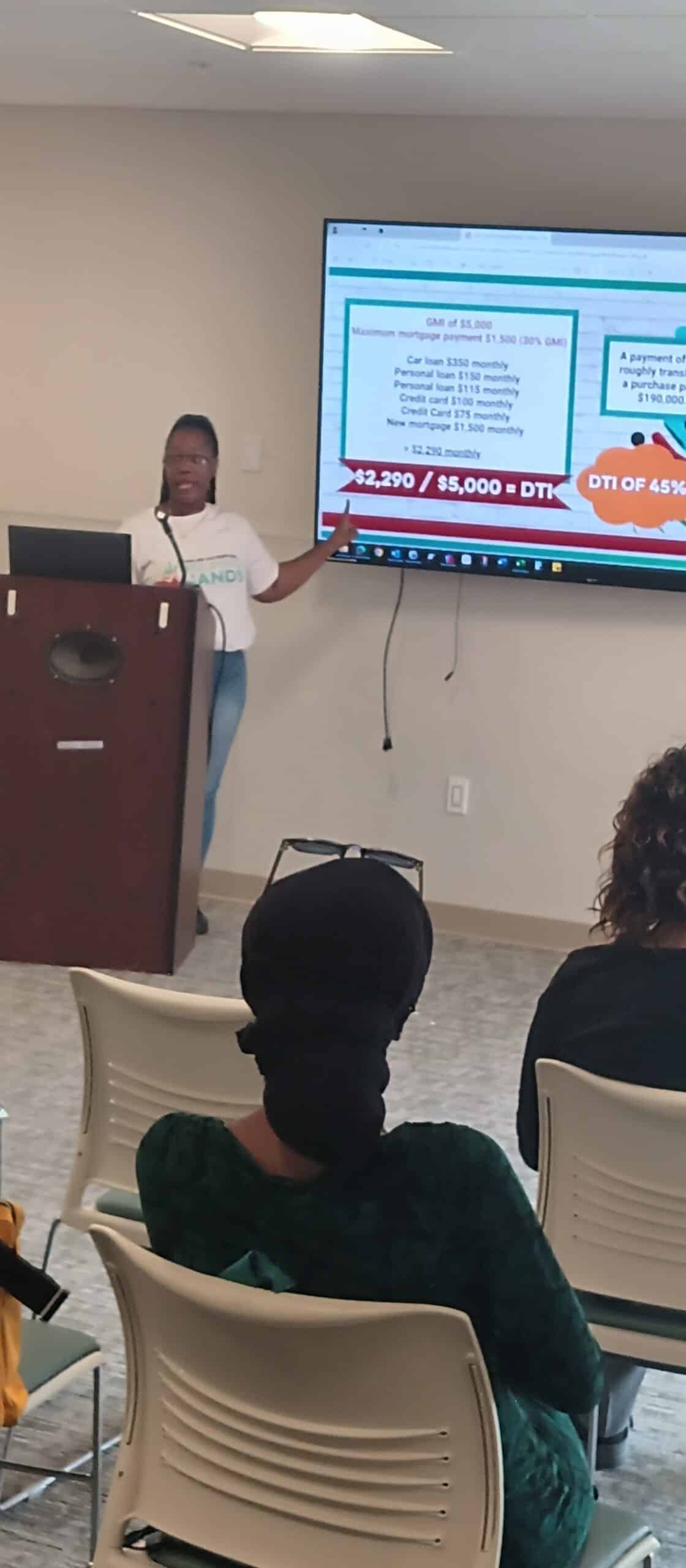 Woman giving a presentation in front of a large screen