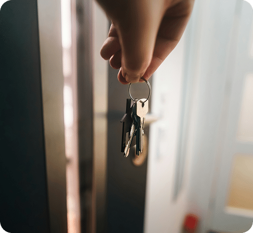 A close up of a hand holding a set of keys