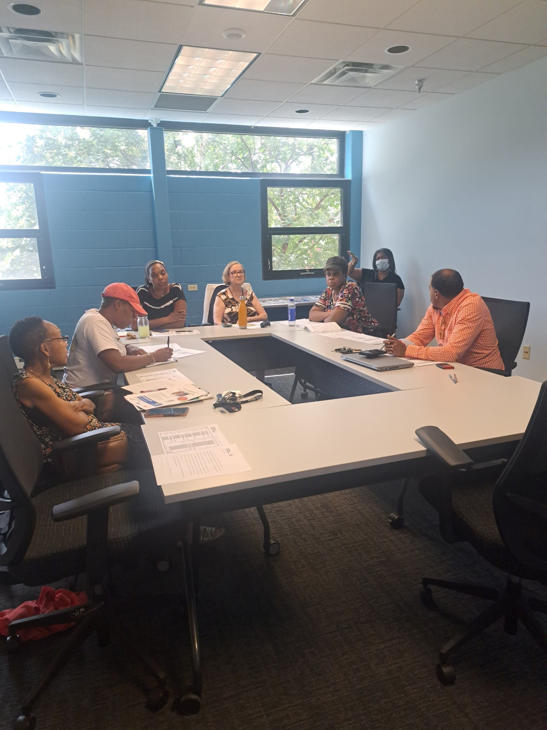 A group of people meeting around a conference table